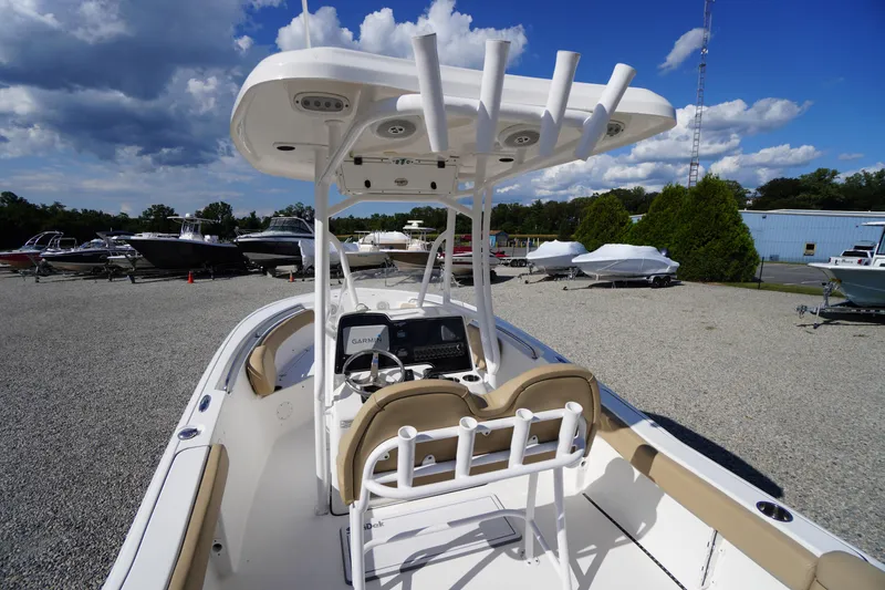 Slide: The Image of 2016 Tidewater 220 LXF boat with T-top and Garmin electronics, displayed outdoors under blue sky. - 30