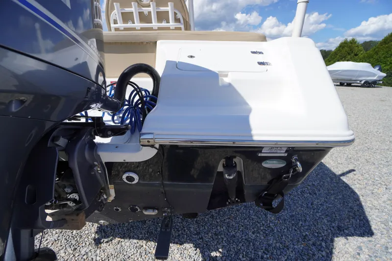 Slide: The Image of 2016 Tidewater 220 LXF boat stern view with motor and cables on gravel. - 32