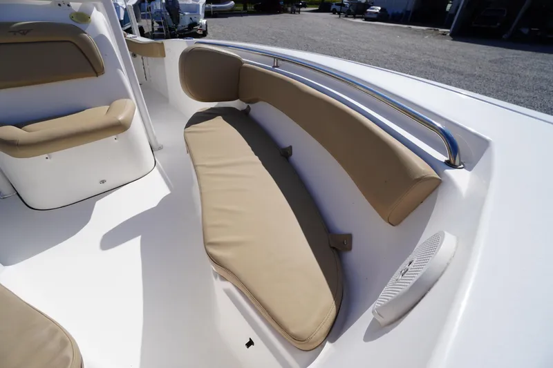 Slide: The Image of 2016 Tidewater 220 LXF boat interior with beige cushioned seating and stainless steel rail. - 7