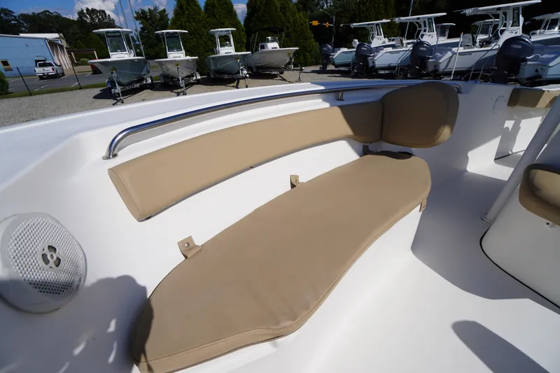 Slide: The Image of 2016 Tidewater 220 LXF boat interior with beige seating and speaker. - 8