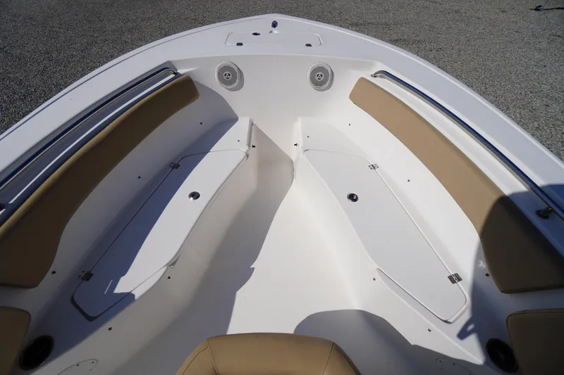 Slide: The Image of 2016 Tidewater 220 LXF boat interior with tan seating and storage compartments. - 9