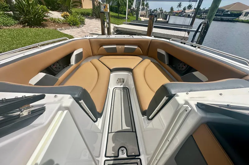 Slide: The Image of 2019 Four Winns HD270 OB boat interior with tan seating and sleek design. - 12