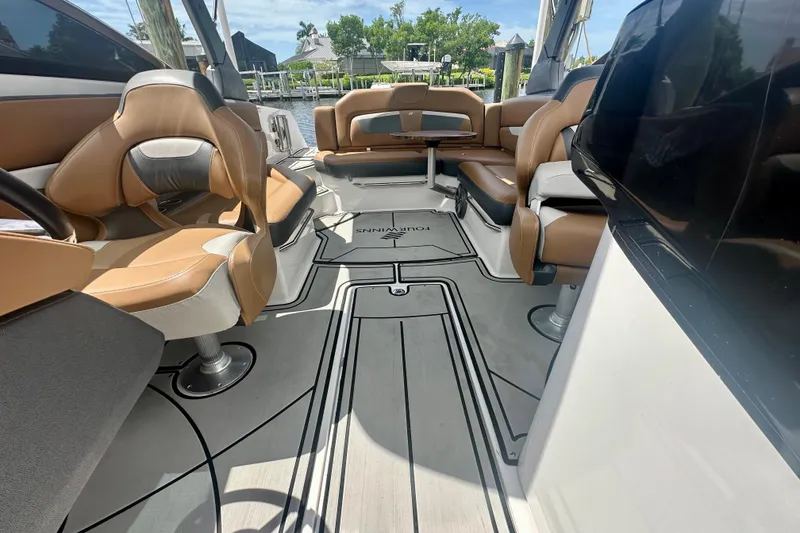 Slide: The Image of 2019 Four Winns HD270 OB boat interior with tan seating and sleek design. - 14