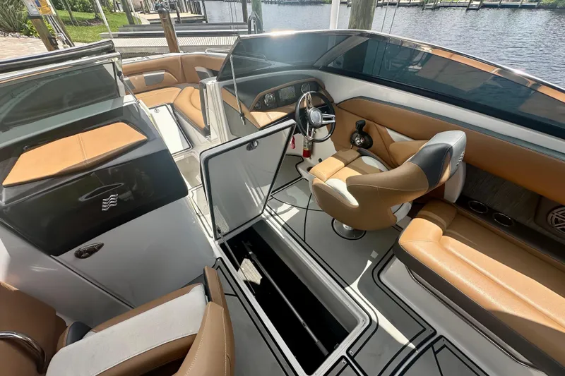 Slide: The Image of 2019 Four Winns HD270 OB boat interior with tan seating and sleek design. - 16