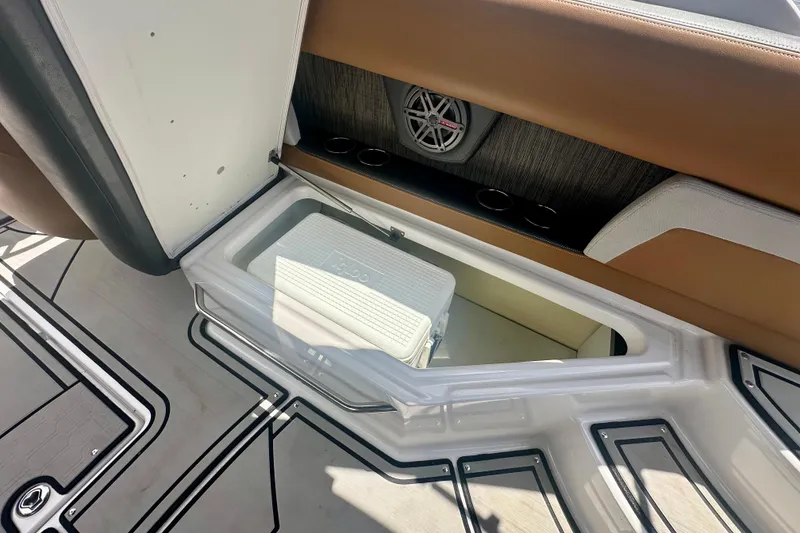 Slide: The Image of 2019 Four Winns HD270 OB boat interior with storage compartment and cooler. - 21