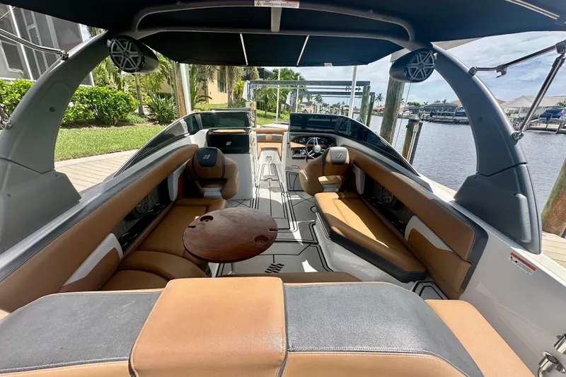 Slide: The Image of 2019 Four Winns HD270 OB boat interior with tan seating and sleek design. - 6