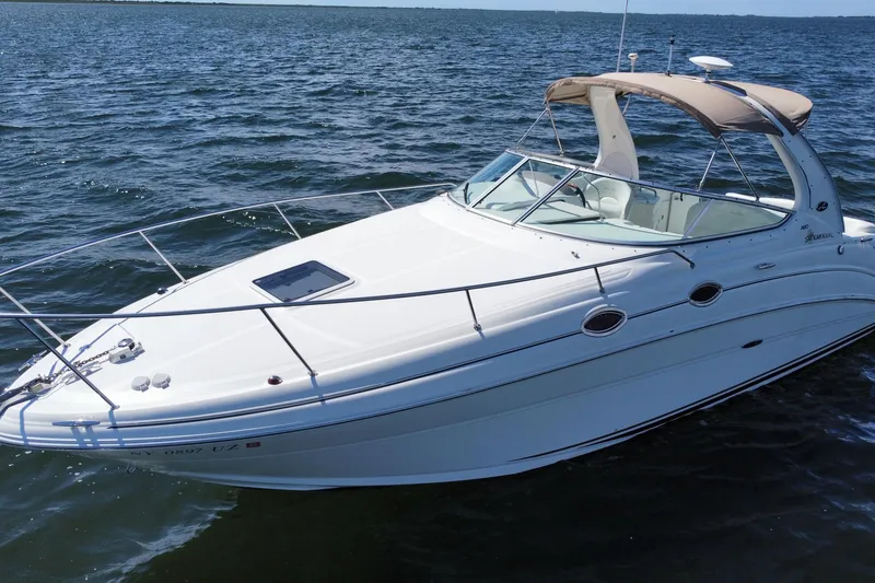 Slide: The Image of 2003 Sea Ray 280 Sundancer boat on open water, featuring sleek design and white exterior. - 2