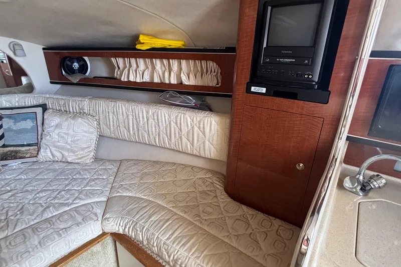 Slide: The Image of Interior of 2003 Sea Ray 280 Sundancer with cozy seating and built-in TV. - 21
