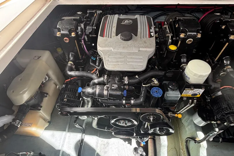 Slide: The Image of Engine compartment of a 2003 Sea Ray 280 Sundancer boat, showcasing detailed components. - 27