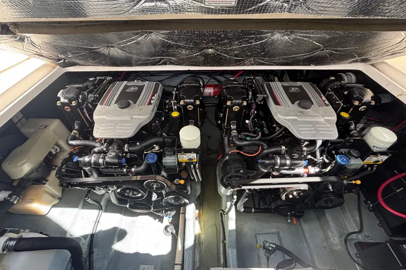 Slide: The Image of Engine compartment of a 2003 Sea Ray 280 Sundancer boat, featuring dual engines. - 29