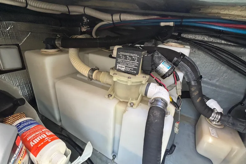 Slide: The Image of Engine compartment of a 2003 Sea Ray 280 Sundancer with visible hoses and components. - 30