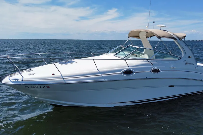Slide: The Image of 2003 Sea Ray 280 Sundancer boat cruising on open water under clear skies. - 5