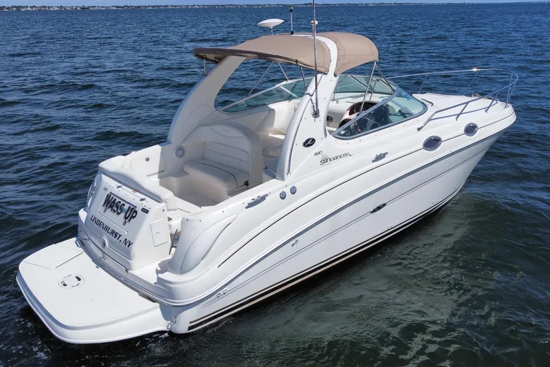 Slide: The Image of 2003 Sea Ray 280 Sundancer boat cruising on open water, featuring sleek white design. - 7
