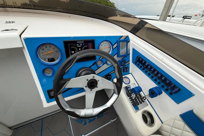 Slide: The Image of 2021 Velocity 290sc boat dashboard with steering wheel, gauges, and control panel. - 19