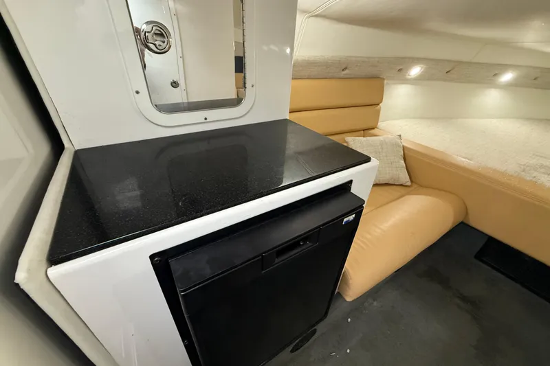 Slide: The Image of Interior of 2021 Velocity 290sc boat with kitchenette and seating area. - 24