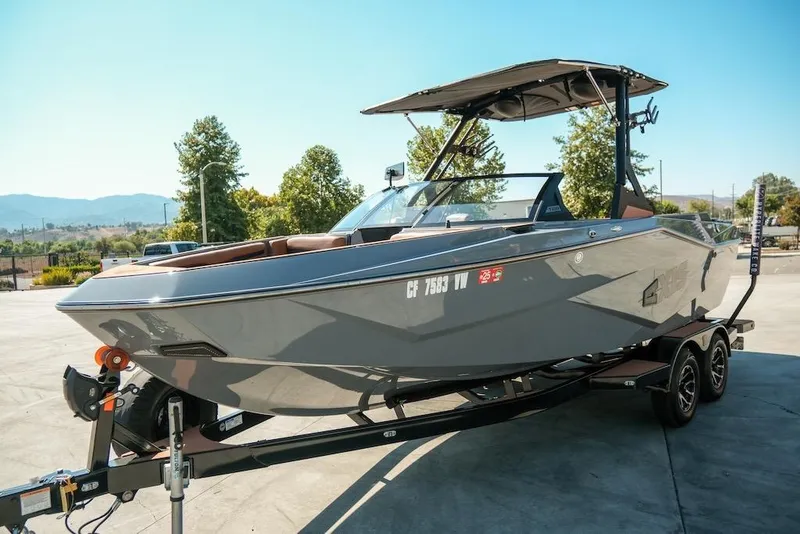 Slide: The Image of 2024 Axis T220 boat on trailer, sleek design, parked outdoors. - 10