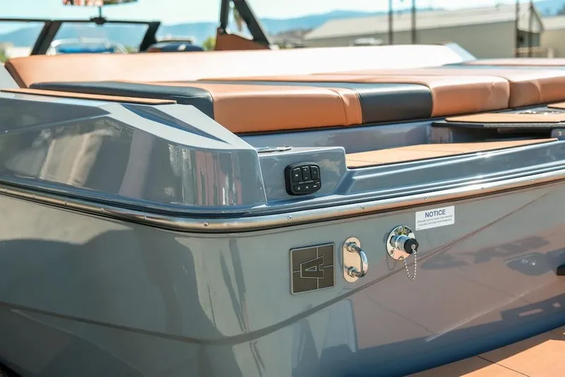 Slide: The Image of 2024 Axis T220 boat rear view with sleek design and tan seating. - 13