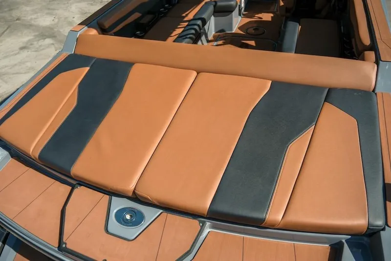 Slide: The Image of 2024 Axis T220 boat interior with tan and black cushioned seating. - 14