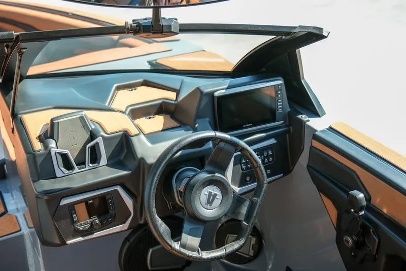 Slide: The Image of 2024 Axis T220 boat dashboard with steering wheel and modern controls. - 17