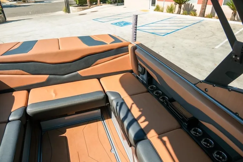 Slide: The Image of 2024 Axis T220 boat interior with tan and black seating, cup holders, and modern design. - 19