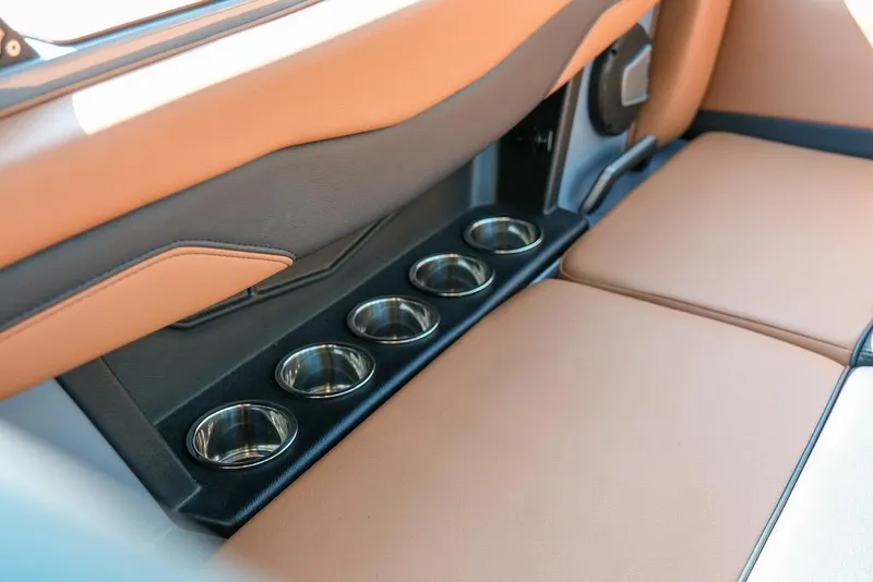 Slide: The Image of 2024 Axis T220 interior with tan leather seats and multiple cup holders. - 26