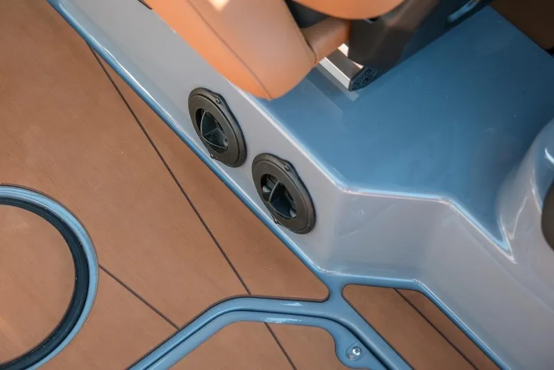 Slide: The Image of 2024 Axis T220 boat interior detail with blue and brown accents. - 28