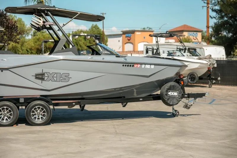 Slide: The Image of 2024 Axis T220 boat on trailer in outdoor dealership setting. - 3