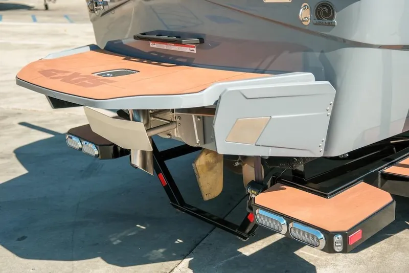 Slide: The Image of 2024 Axis T220 boat rear view with swim platform and wakeboard features. - 4