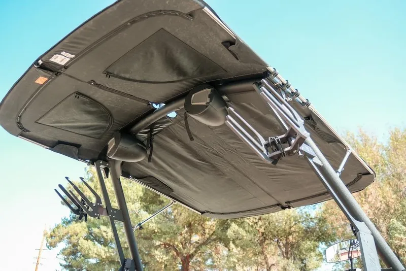 Slide: The Image of 2024 Axis T220 boat canopy with speakers and racks, set against a clear sky. - 7