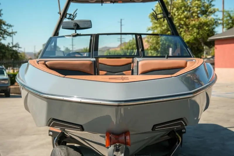 Slide: The Image of 2024 Axis T220 boat with sleek design and tan interior, parked outdoors. - 9