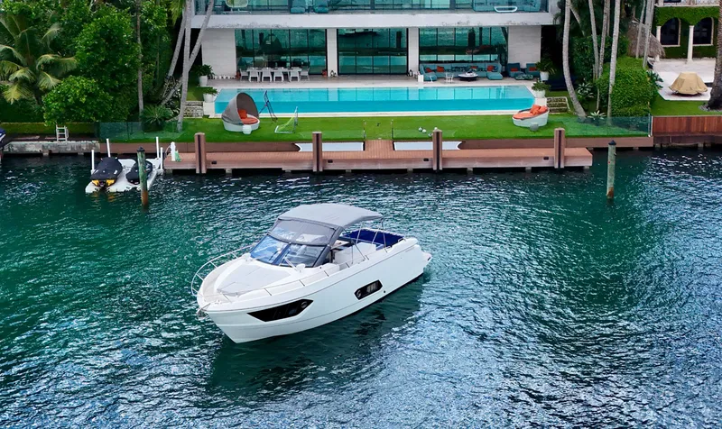 Slide: The Image of Luxury Absolute 40 yacht on water near modern waterfront mansion, 2014 model. - 12