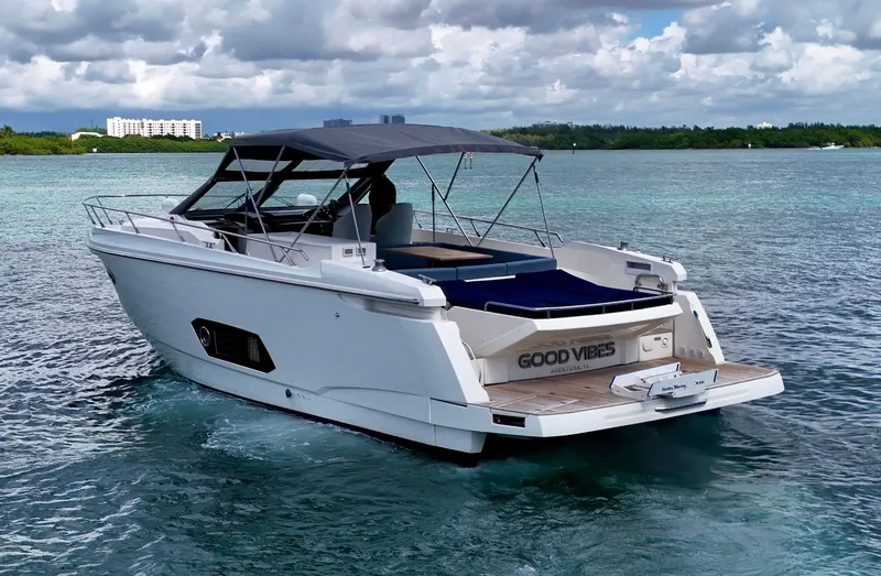 Slide: The Image of Luxury Absolute 40 yacht cruising on clear waters, 2014 model, with "Good Vibes" on the stern. - 18