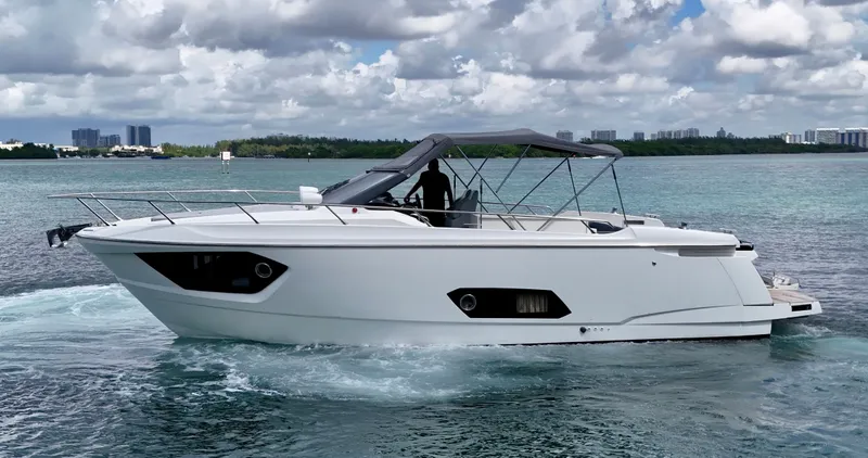 Slide: The Image of 2014 Absolute 40 yacht cruising on a serene, blue waterway under a cloudy sky. - 21