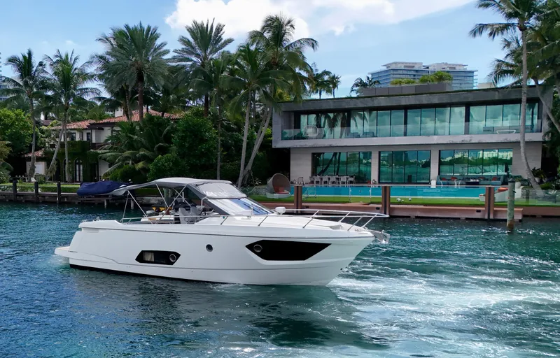 Slide: The Image of Luxury Absolute 40 yacht cruising near waterfront mansion, surrounded by palm trees. - 24
