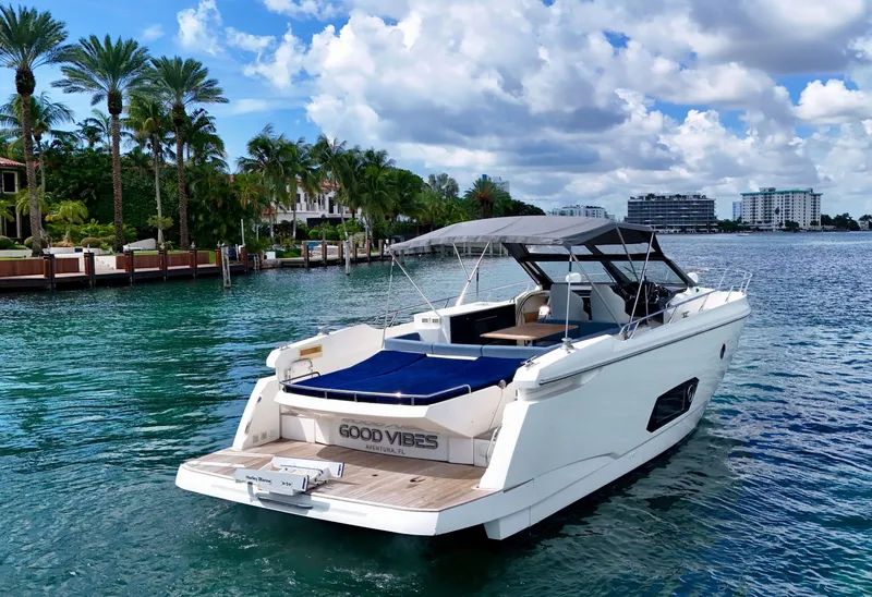 Slide: The Image of Luxury Absolute 40 yacht on clear water, surrounded by palm trees and buildings, 2014 model. - 25