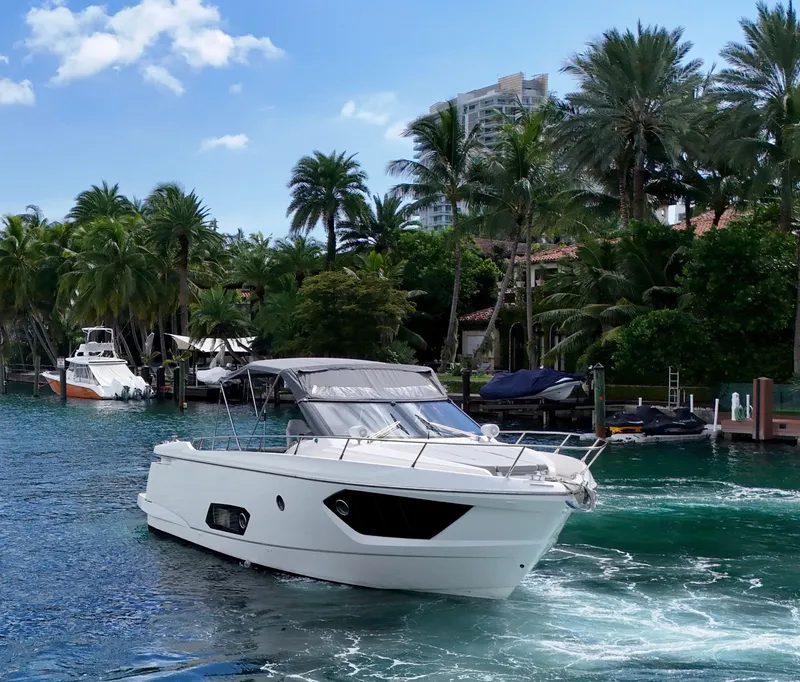 Slide: The Image of Luxury Absolute 40 yacht cruising in tropical waters, surrounded by lush palm trees. - 26