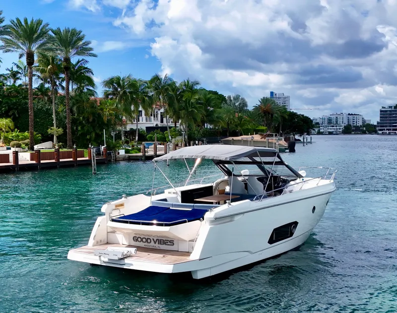 Slide: The Image of Luxury Absolute 40 yacht cruising in tropical waters, surrounded by palm trees and waterfront homes. - 28