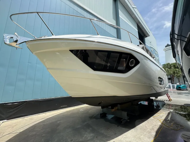 Slide: The Image of 2014 Absolute 40 yacht docked in a marina, showcasing sleek design and modern features. - 43