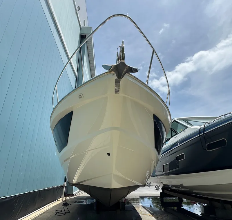 Slide: The Image of 2014 Absolute 40 yacht in dry dock, viewed from the front under a clear sky. - 44