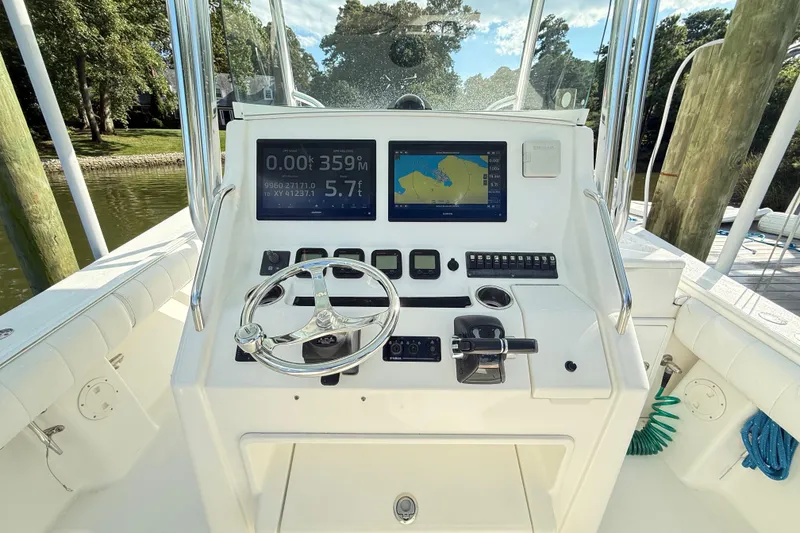 Slide: The Image of 2009 Regulator 34SS boat helm with navigation screens and steering wheel. - 10