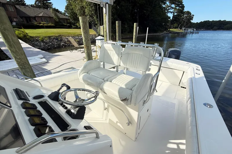 Slide: The Image of 2009 Regulator 34SS boat dashboard with navigation screens and steering wheel. - 11