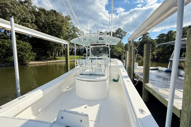 Slide: The Image of 2009 Regulator 34SS boat interior with steering wheel and seating at dock. - 12