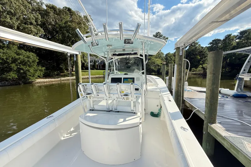 Slide: The Image of 2009 Regulator 34SS boat with rod holders and electronics, set against a clear blue sky. - 13