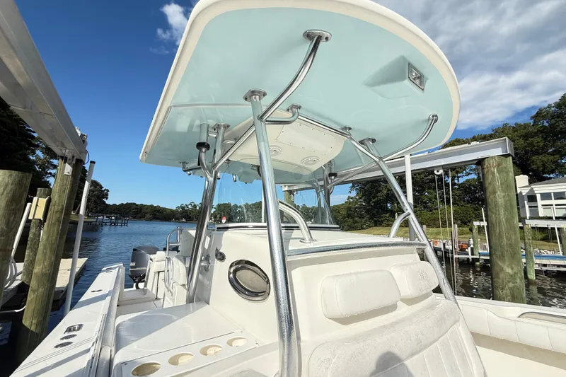 Slide: The Image of 2009 Regulator 34SS boat docked, featuring a spacious deck and modern helm. - 17