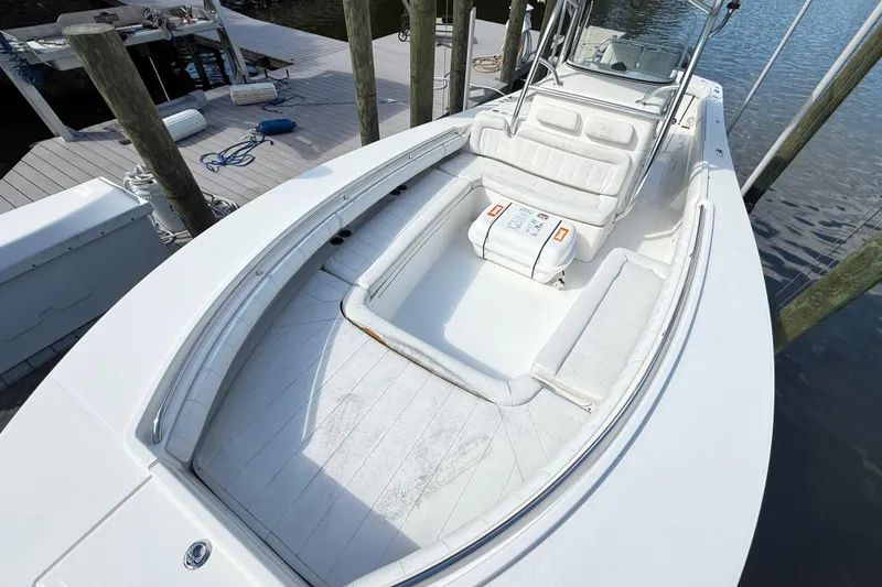 Slide: The Image of 2009 Regulator 34SS boat docked by a scenic waterfront under a clear blue sky. - 19