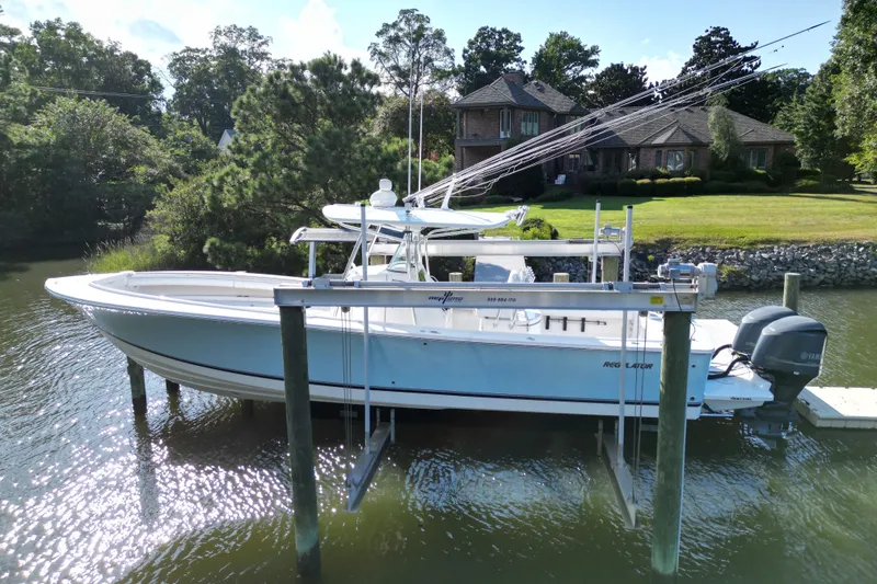 Slide: The Image of 2009 Regulator 34SS boat cruising on a calm lake. - 2