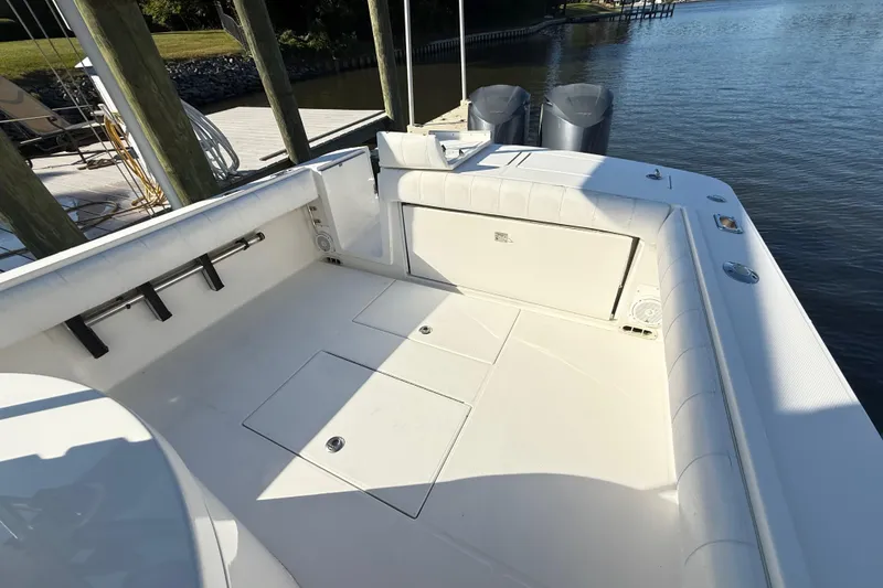 Slide: The Image of 2009 Regulator 34SS boat on calm water, clear sky, and forested shoreline. - 20