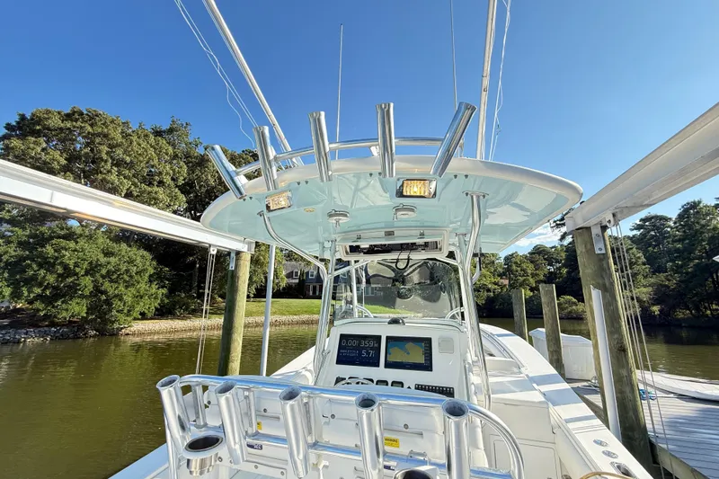 Slide: The Image of 2009 Regulator 34SS boat on a sunny lake, showcasing spacious deck and sleek design. - 21