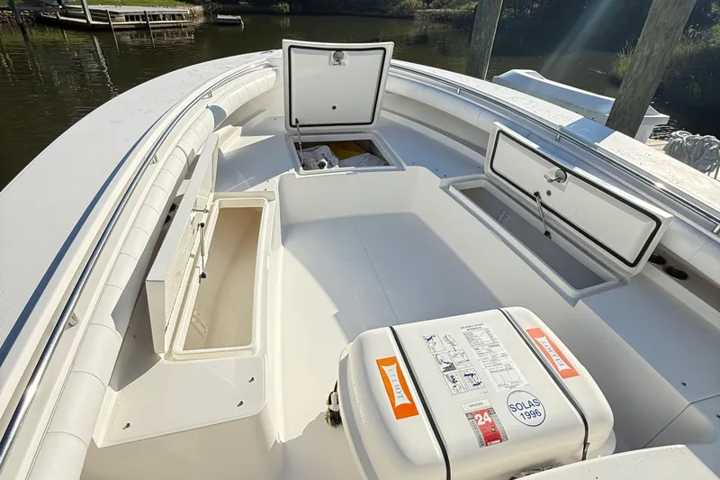 Slide: The Image of 2009 Regulator 34SS boat on a sunny lake, open storage compartments visible. - 22