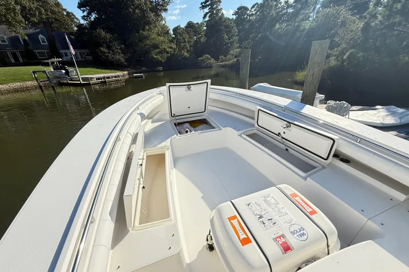 Slide: The Image of 2009 Regulator 34SS boat with white cushioned seating, docked by the water. - 23